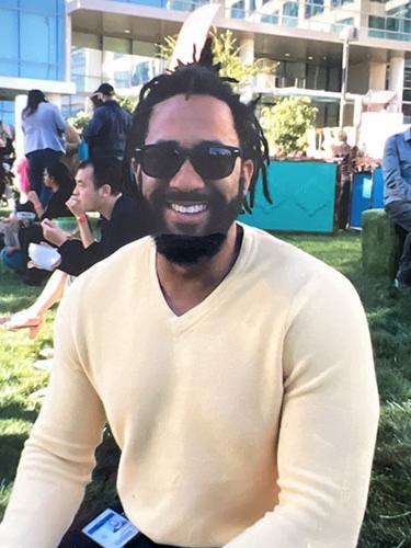 Smiling man in yellow sweater